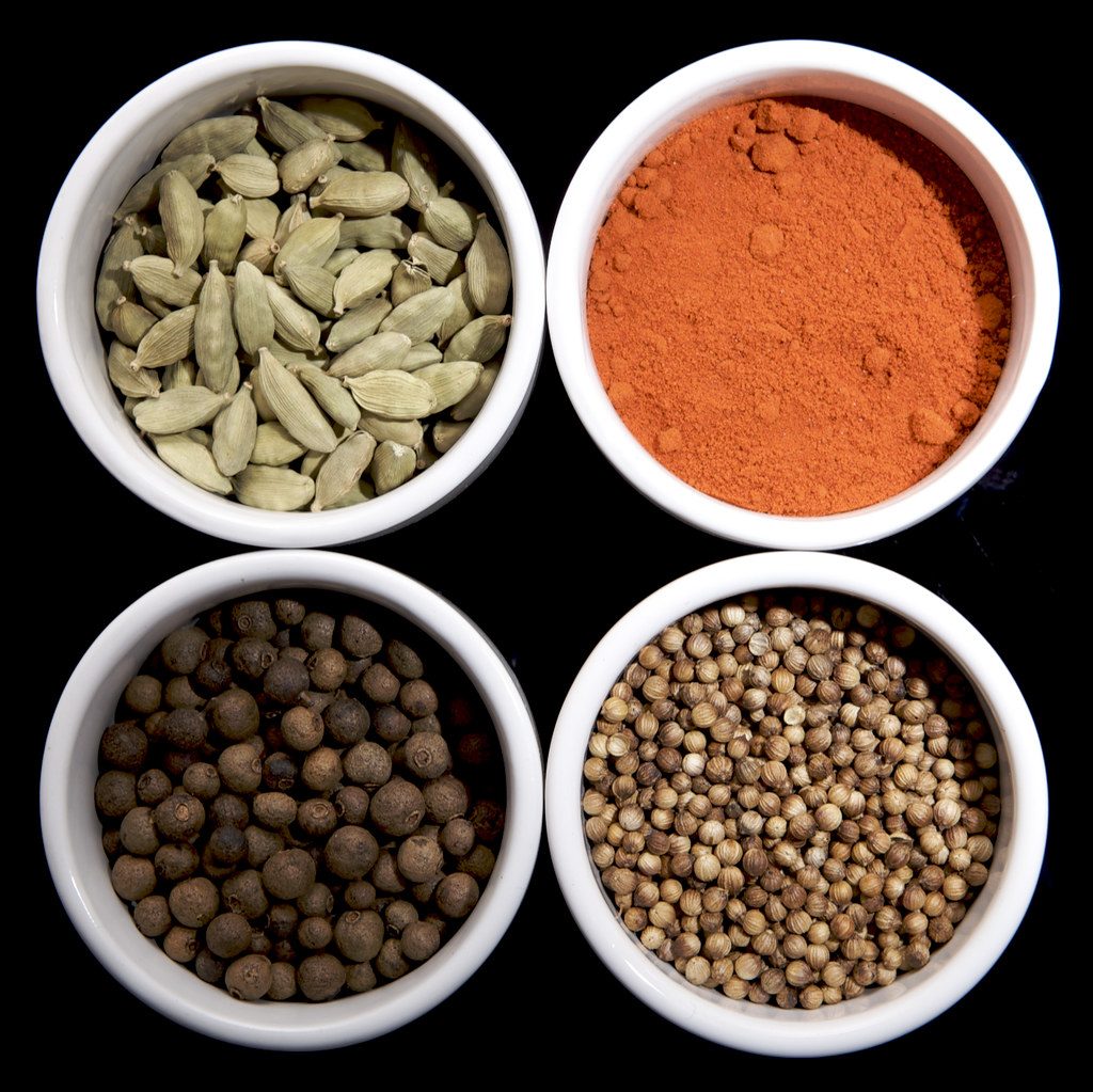 An array of herbs and spices in small bowls